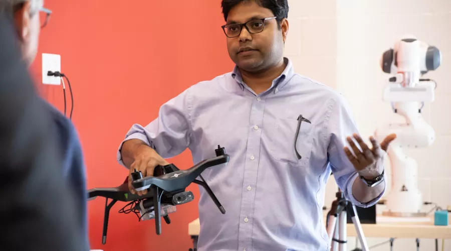 Dr. Sabur Baidya talking while holding a drone.