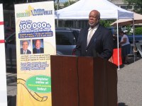 Dr. Troutman speaking at podium during farmers market press event