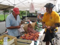 Dr. Troutman interacting with one of our farmers after a bike ride,