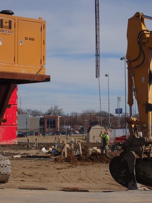 Worker installing geothermal well at New Engineering Building