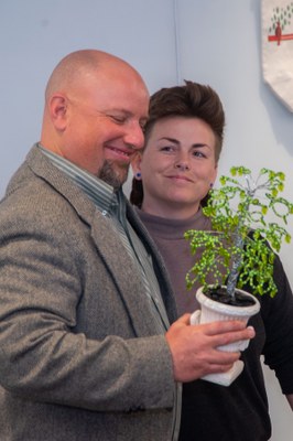 15th Anniversary Celebration March 2023 - Justin Mog receives hand-made award from the Sustainability Interns, represented by Robin Frederick